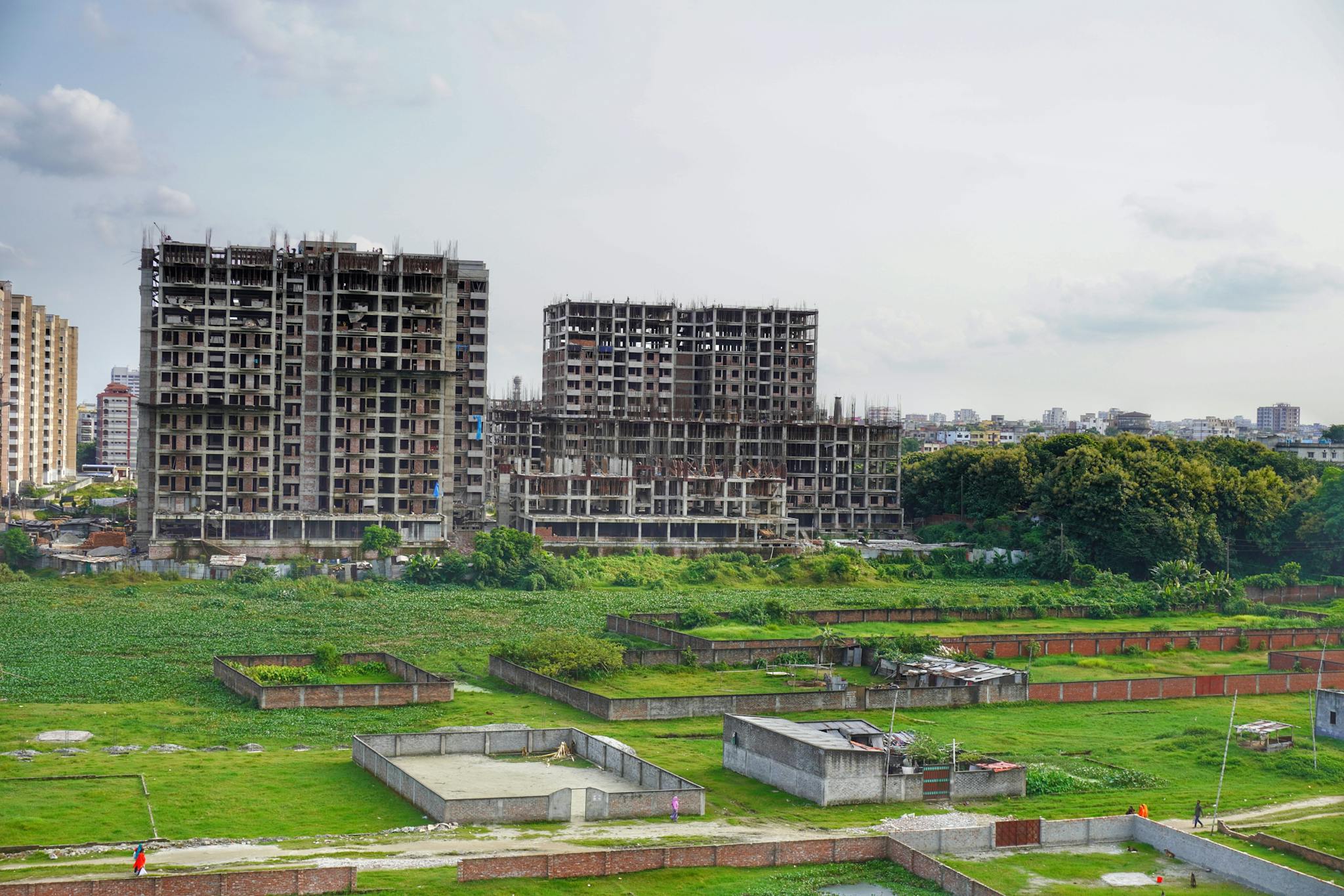 High-rise buildings under construction in urban Bangladesh, showcasing modern development.